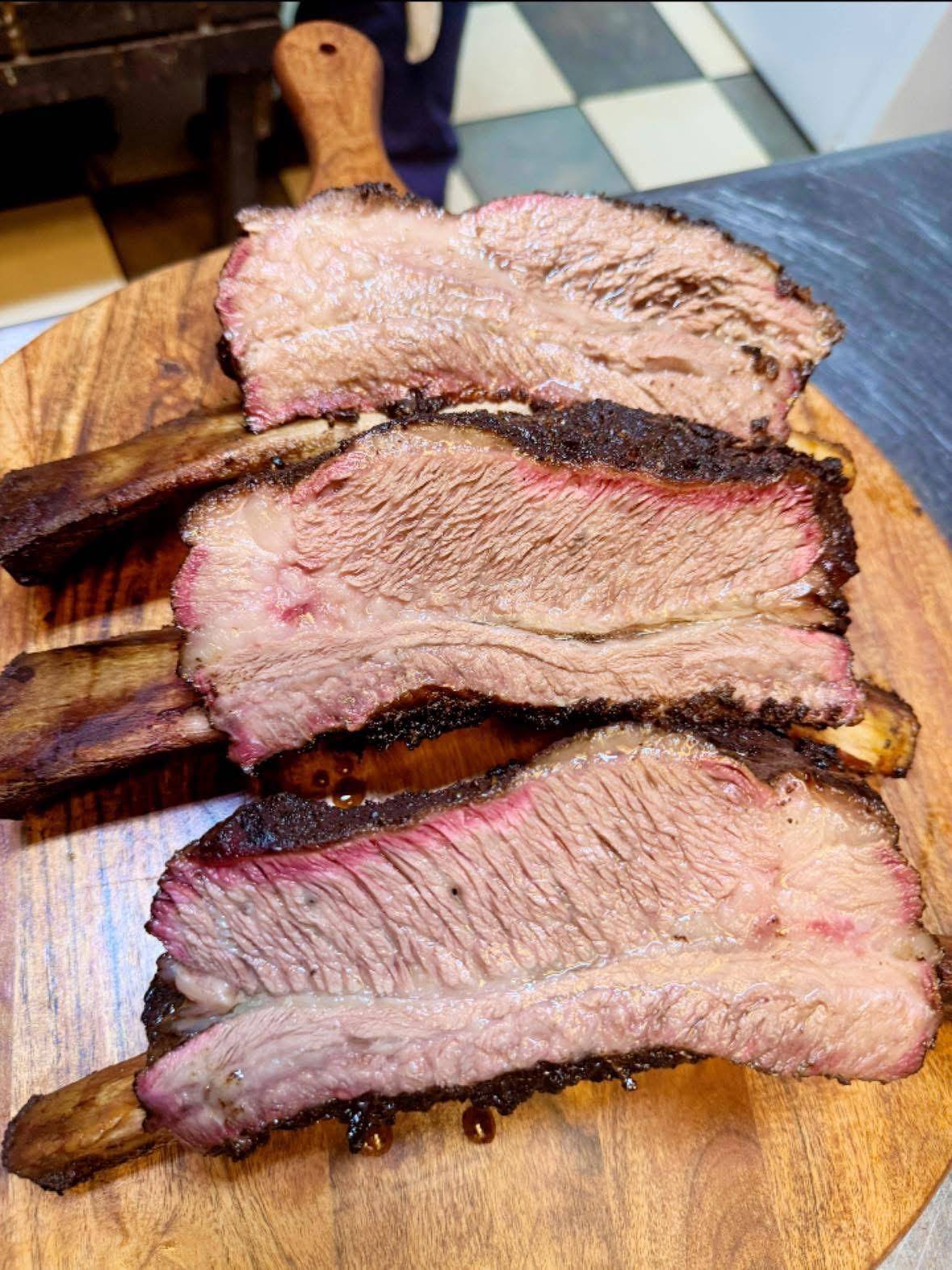 Sliced smoked brisket with a dark bark